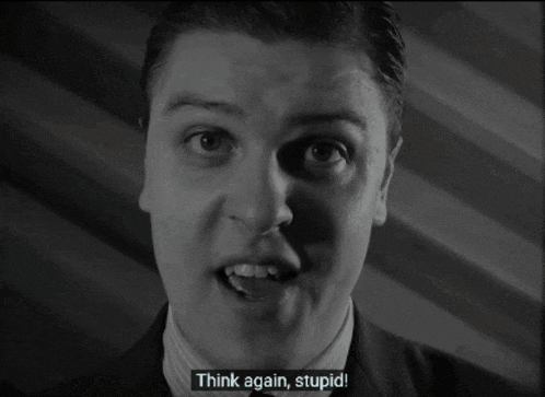 a man in a suit says think again stupid in a black and white photo