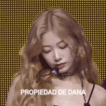a woman with a choker around her neck and the words propiedad de dana written below her