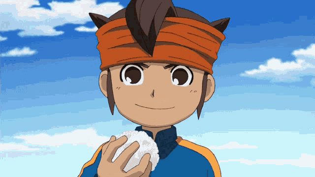 a boy with an orange headband is holding a ball of rice in his hand