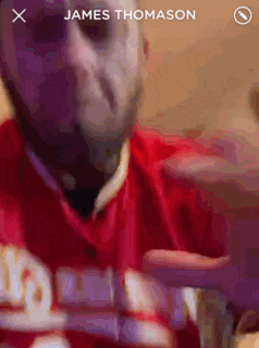 a man in a red shirt with the name james thomason at the bottom