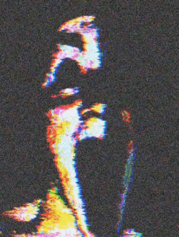 a blurry picture of a man 's face with a rainbow of colors .