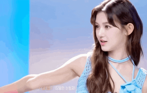the girl is wearing a blue dress and a blue choker .