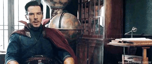a man in a doctor strange costume is sitting in a chair in front of a globe .