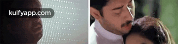 a man is kissing a woman on the forehead in a close up of a movie scene .