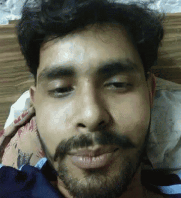 a man with a beard is laying on a bed