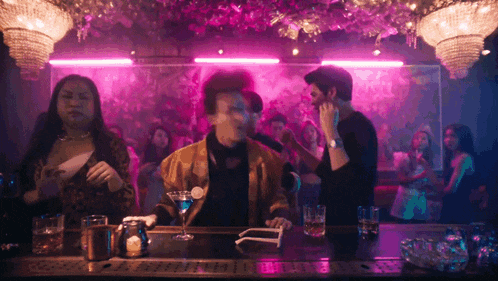 a man sitting at a bar with a martini glass