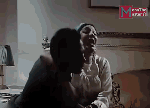 a man kisses a woman on the cheek in front of a sign that says menathe asterion