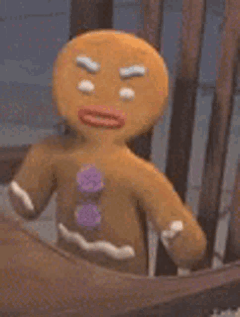 a gingerbread man is sitting in a wooden chair .