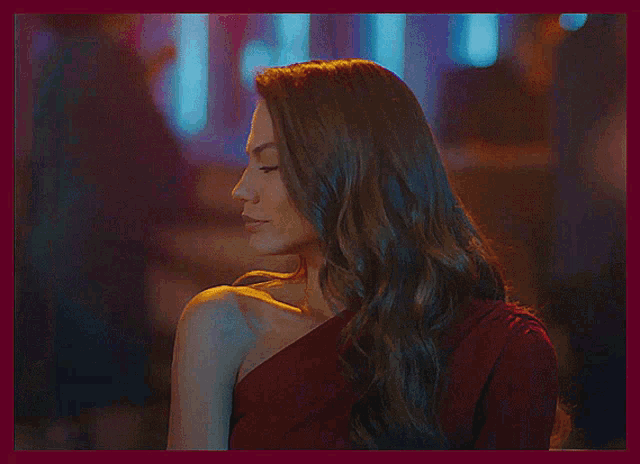 a woman in a red dress is dancing and looking up