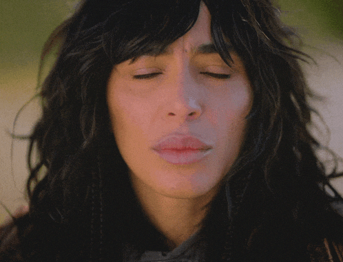 a close up of a woman 's face shows her eyes closed