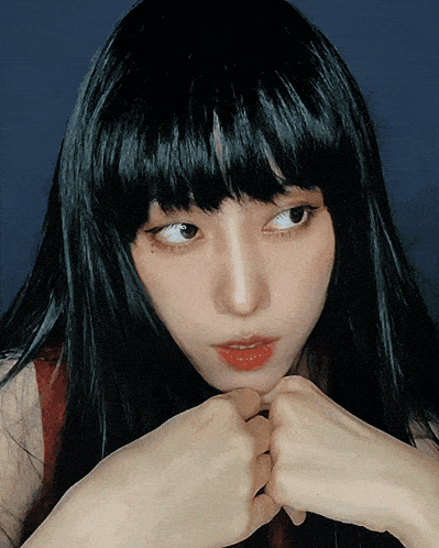 a close up of a woman 's face with black hair and red lips