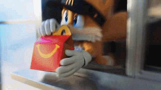 a cartoon character is holding a happy meal