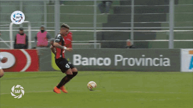 a soccer game is being played in front of an ad for cetrogar
