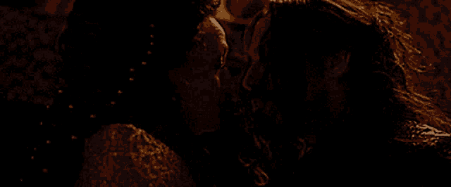 a man and a woman kissing in the dark