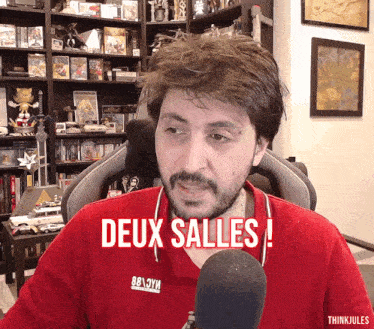 a man wearing a red shirt with the word deux salles on it