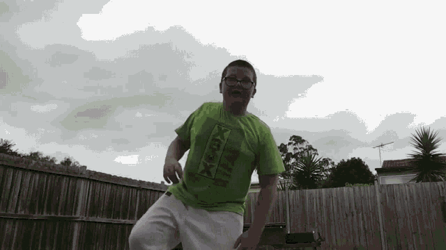 a boy wearing a green shirt with xbox on it
