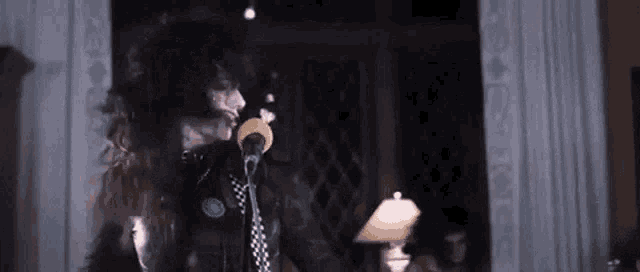 a person is singing into a microphone in a room .