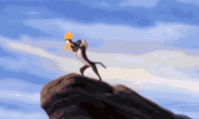 a cartoon monkey is standing on top of a rock holding a yellow object .