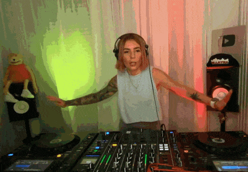 a woman wearing headphones stands in front of a dj mixer with a youtube logo on it