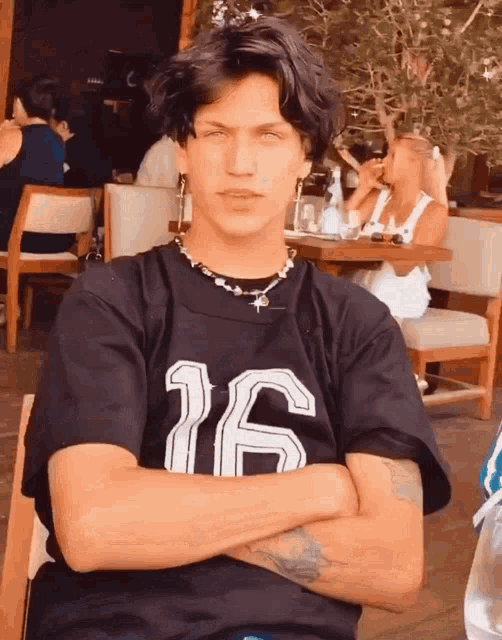 a man in a black shirt with the number 16 on it