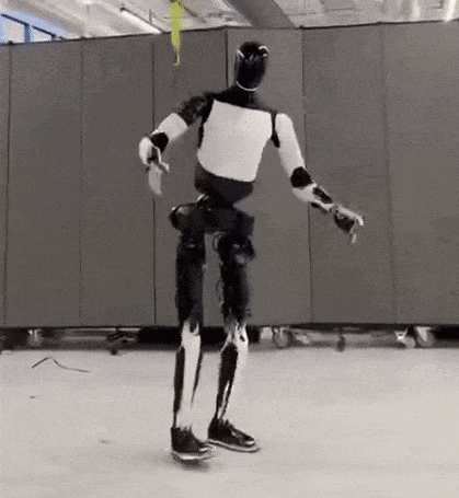 a black and white robot is standing on a skateboard in a room .