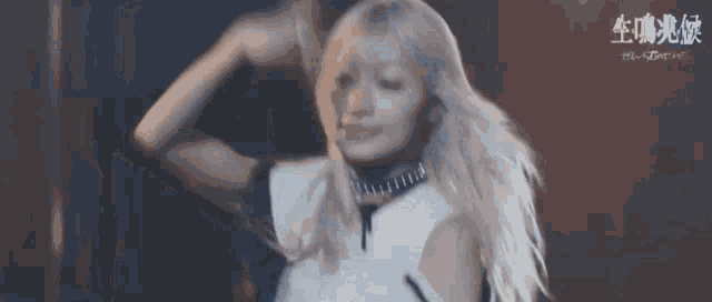 a woman with blonde hair is standing in front of a black background .