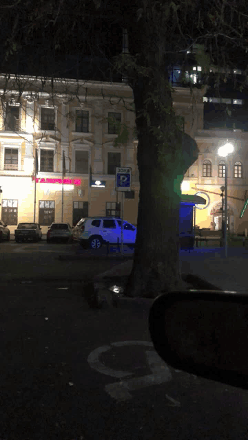 a white suv is parked in front of a building with a sign that says doha