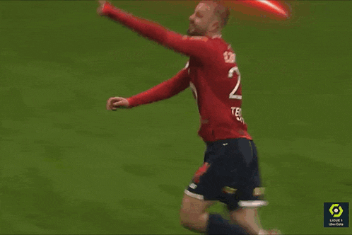 a soccer player in a red jersey with the number 21 on it