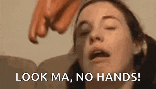 a close up of a woman 's face with a hand pointing at it and the words `` look ma , no hands ! ''