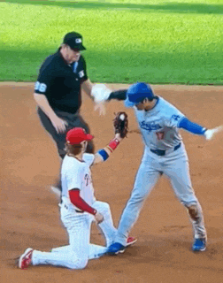 a baseball player in a dodgers uniform is getting ready to catch a ball