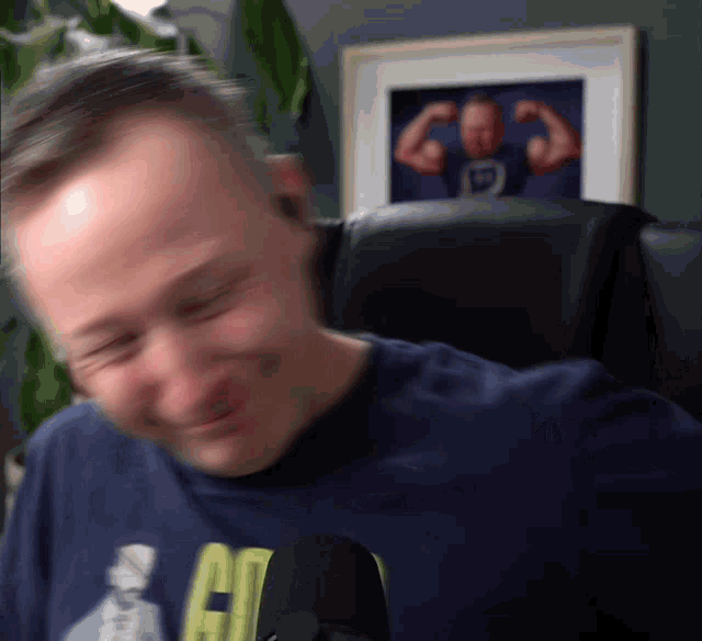 a blurry picture of a man in a blue shirt with the letter c on it