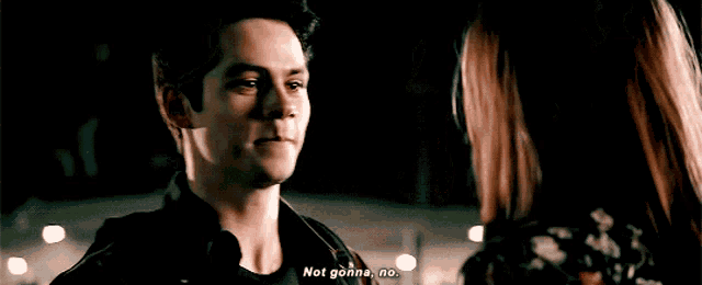 a man and a woman are looking at each other and the man is saying not gonna no