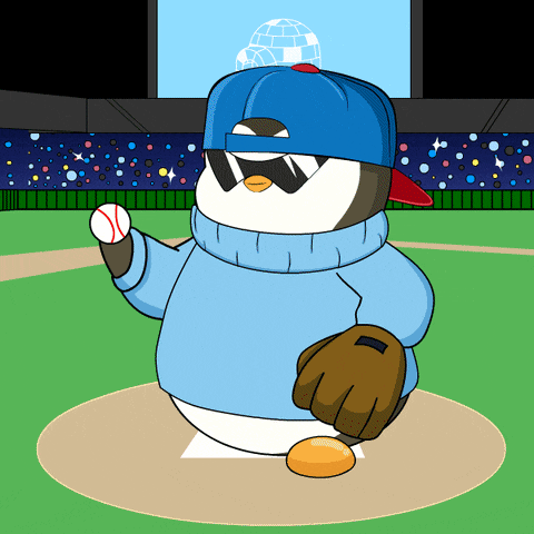 a penguin wearing a blue hat and sunglasses is throwing a baseball on a baseball field