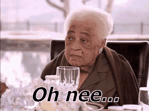 an elderly woman is sitting at a table with a glass of wine and the words oh nee .