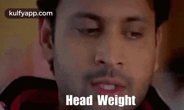 a close up of a man 's face with the words `` head weight '' coming out of his mouth .