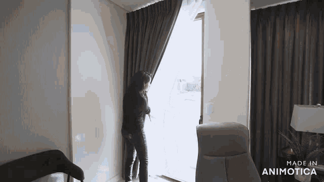 a woman is opening a door in a room with the words made in animotica on the bottom