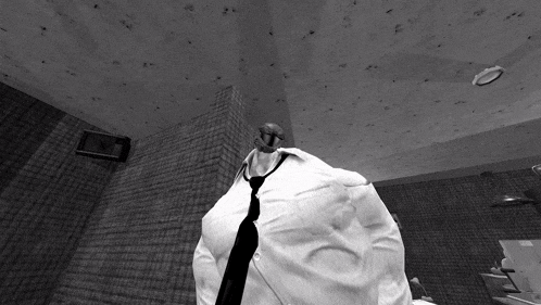 a man in a white shirt and black tie stands in a room