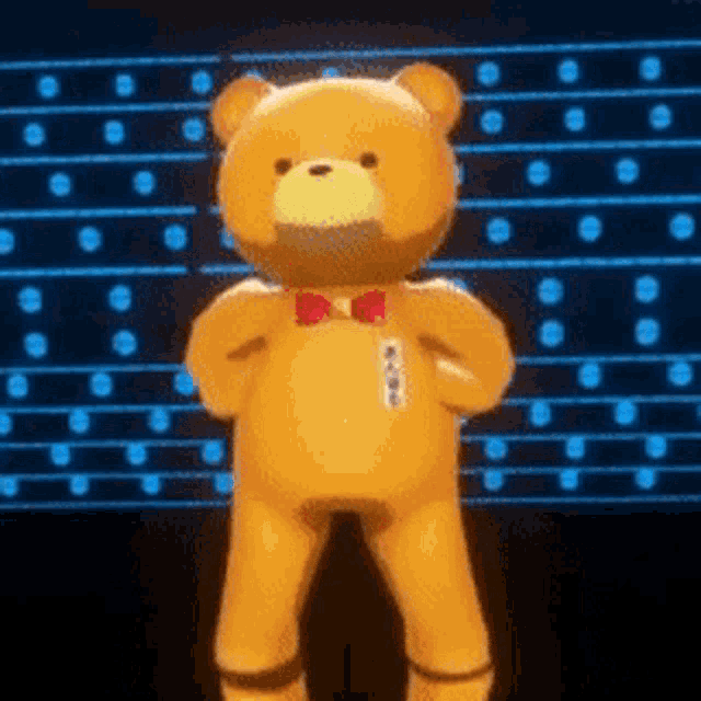 a teddy bear wearing a bow tie is standing in front of a blue wall