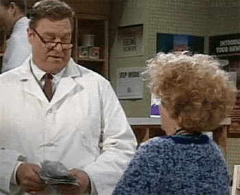 a man in a lab coat is talking to a woman