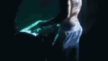 a blurry image of a person dancing in a dark room