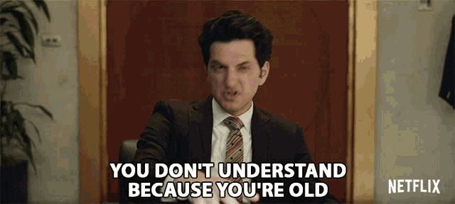 a man in a suit and tie says you don t understand because you 're old