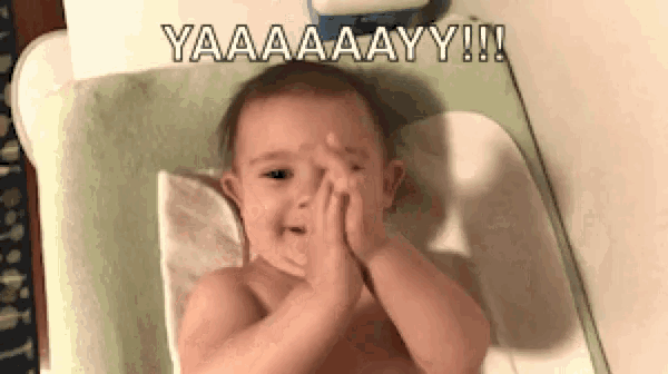 a baby is crying while laying on a changing table .