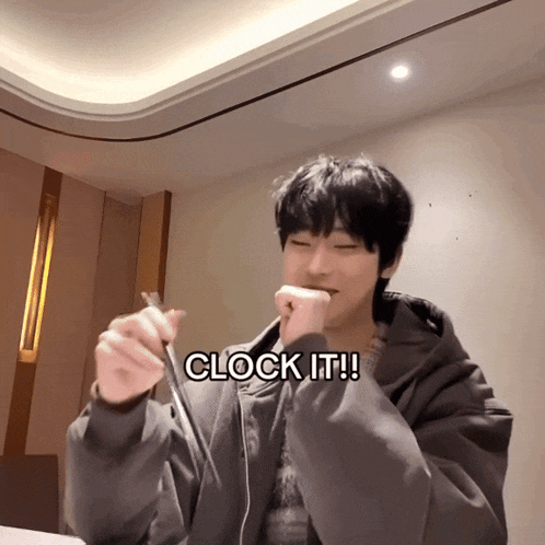 a man with a clock in his hand and the words clock it