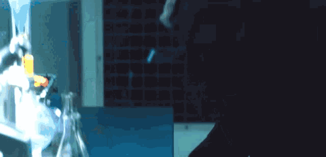a blurred image of a person in a dark room