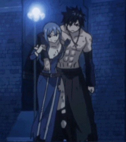 a man and a woman standing next to each other in front of a brick wall
