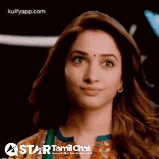 a close up of a woman 's face with a star tamil chat logo in the background