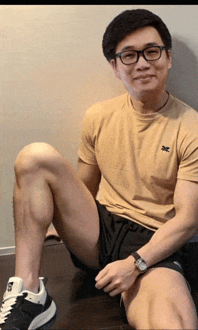 a man wearing a yellow t-shirt with a x on it