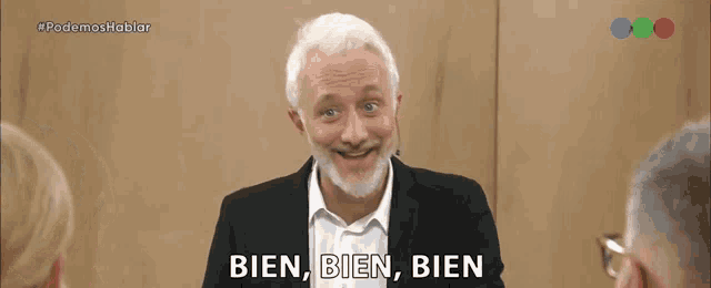a man with a beard is smiling and says bien bien bien