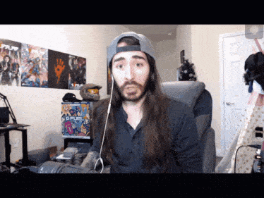 a man with long hair is wearing a hat that says ps4