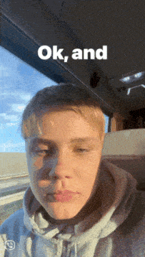 a young man sitting in front of a window with the words " ok and " above his head
